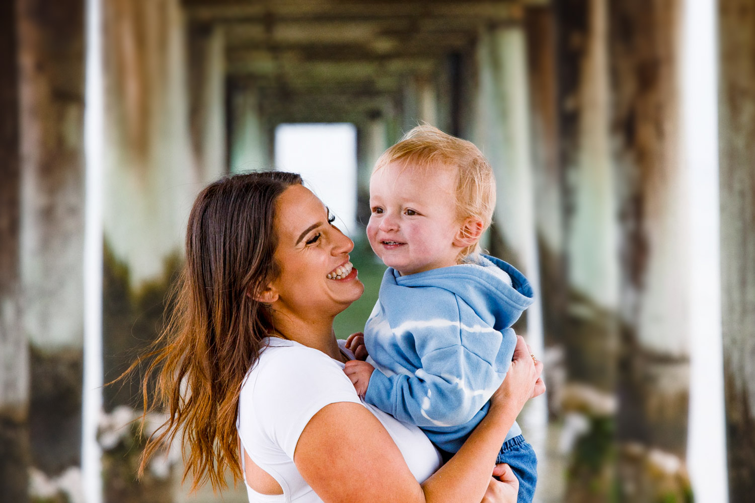 Mother and son under pier