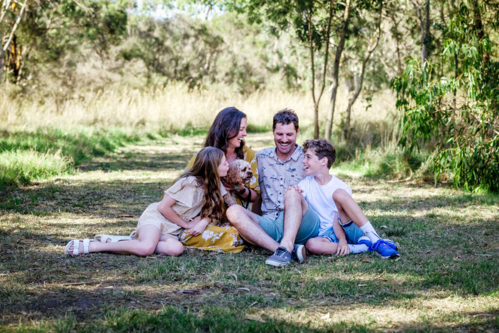 Candid family at the park with dog