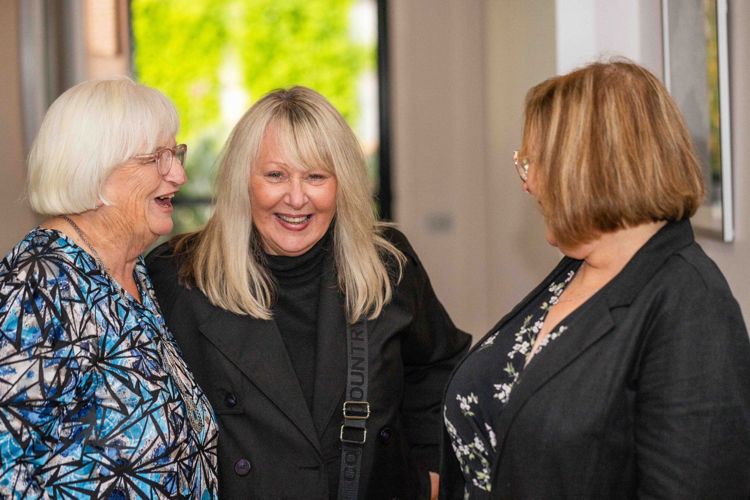 Candid portrait of lady laughing with friends