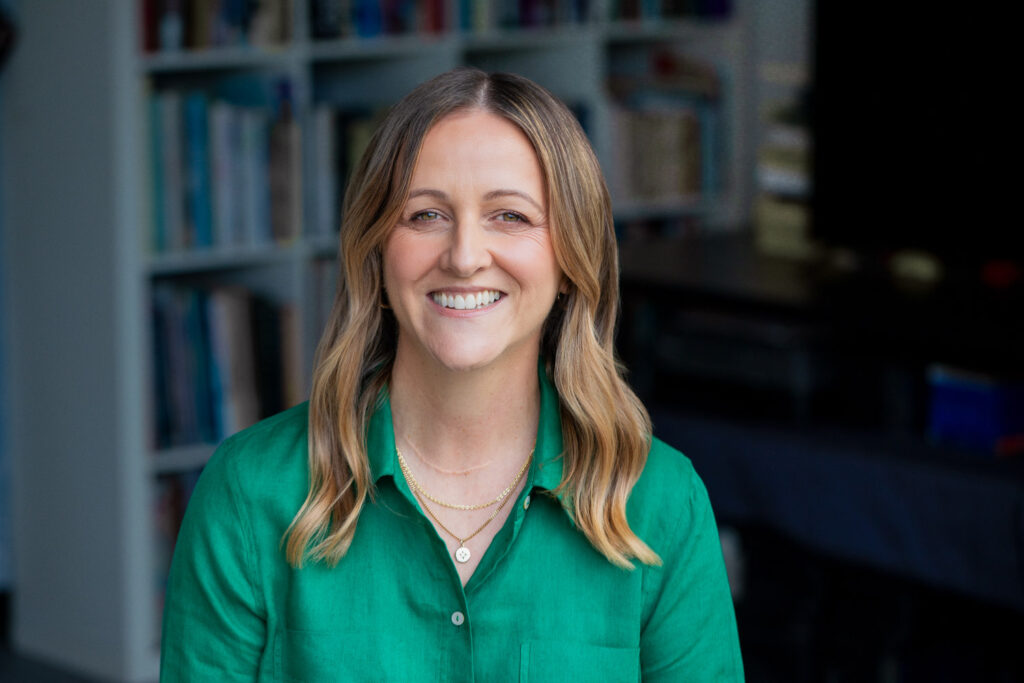 Author's portrait with bookshelf backdrop