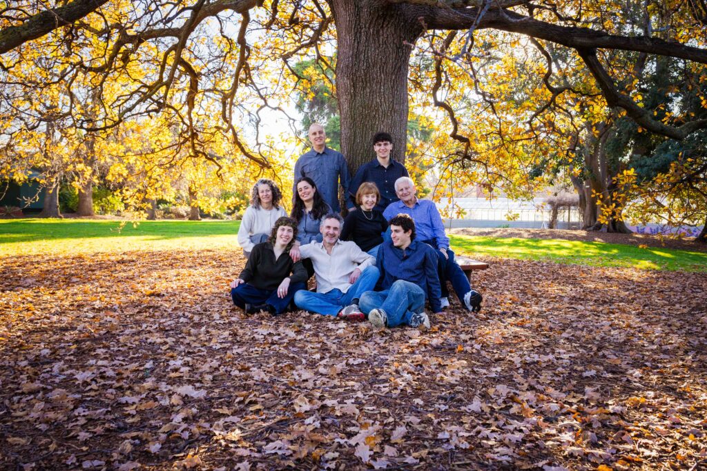 Family in garden under tree golden light