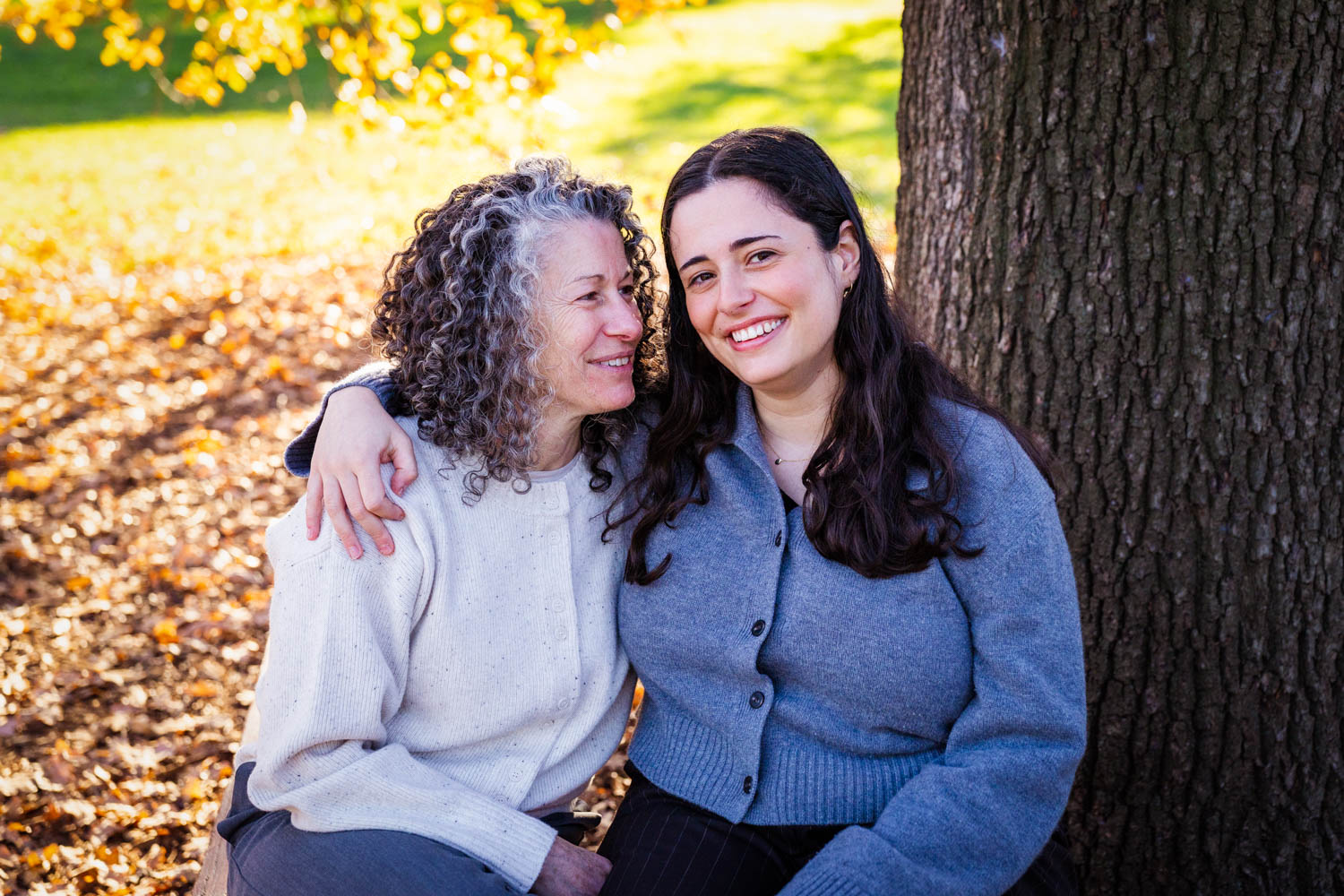 Family in garden under tree golden light