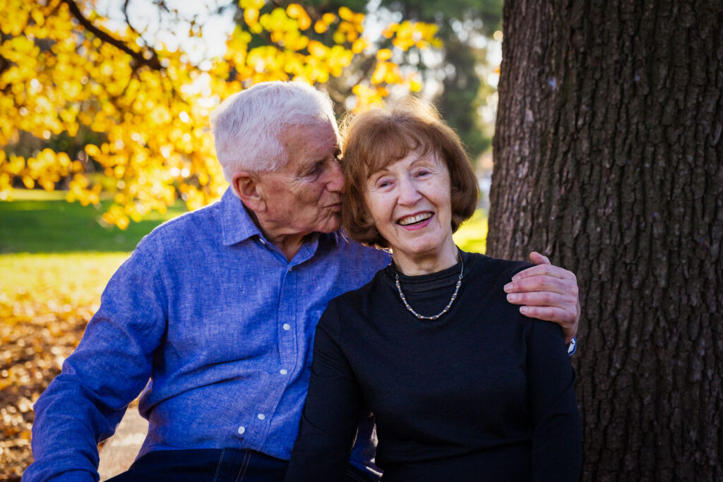 Family in garden under tree golden light